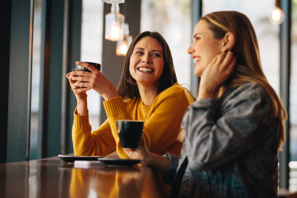 Two friends enjoying coffee at a cafe.