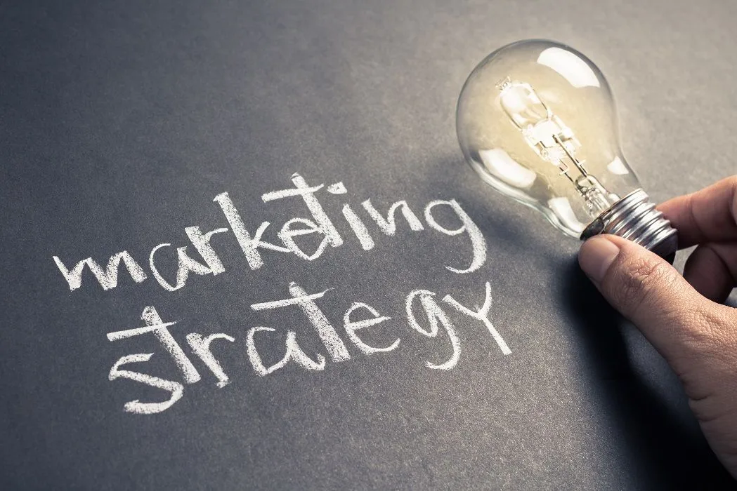 Marketing strategy written with light bulb creativity
