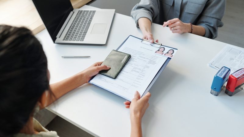 Woman handling passport and visa application form