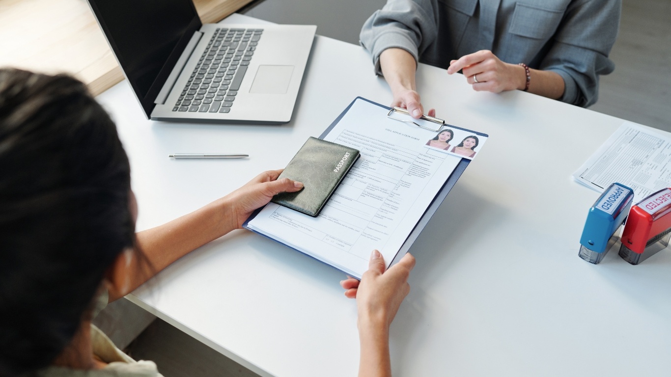 Woman handling passport and visa application form