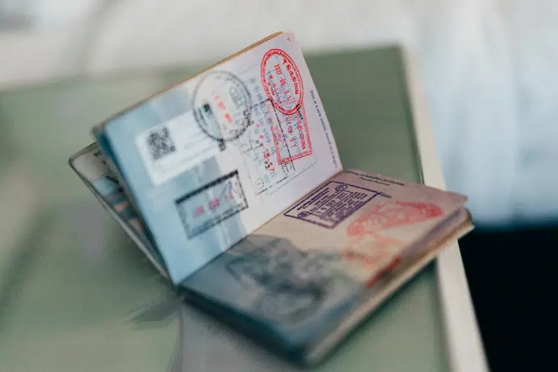 Open passport with multiple stamps on pages.