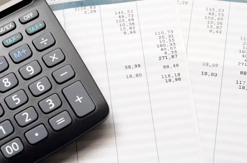 Calculator and printed financial receipts close-up.