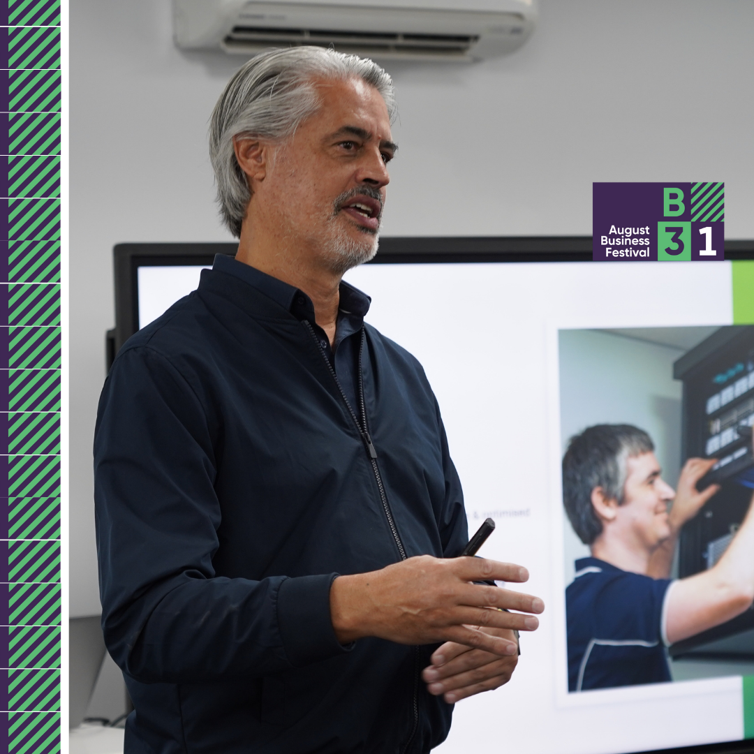 Man speaking at August Business Festival presentation.