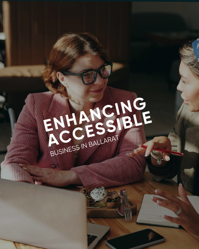 Two women discussing accessibility in Ballarat business meeting.