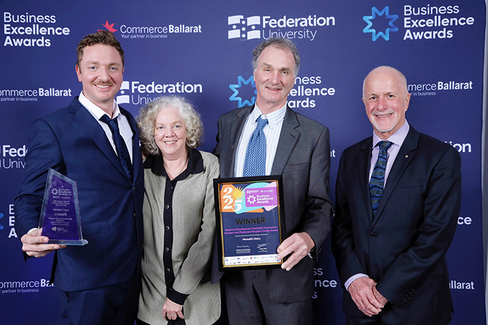 Group with award at Business Excellence Awards.