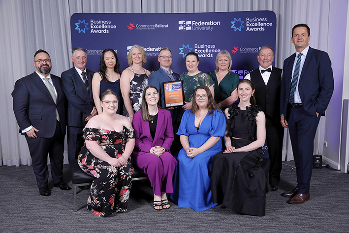 Group celebrating Business Excellence Awards achievement.