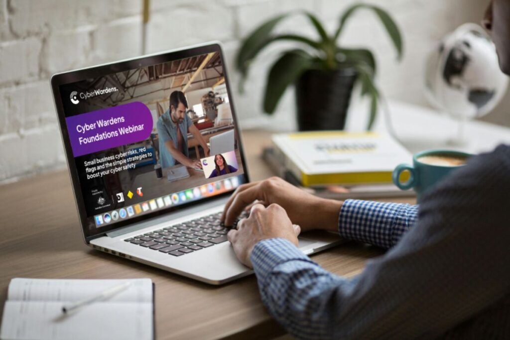Person attending Cyber Wardens webinar on laptop