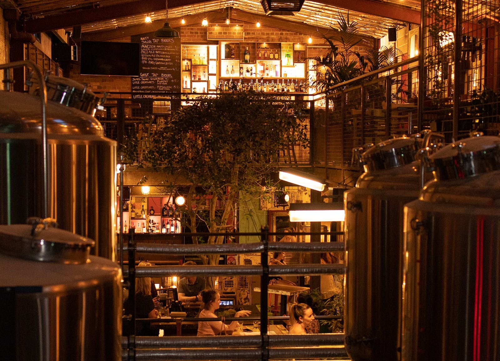 Cozy brewery interior with people dining.